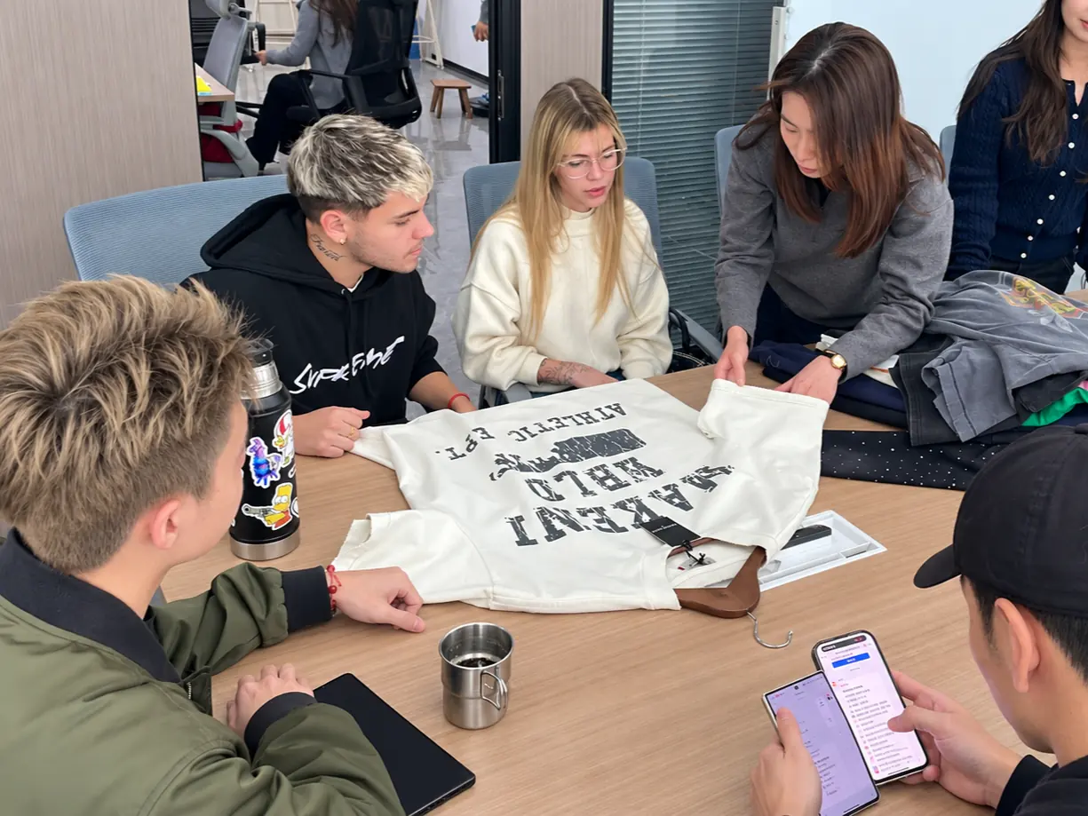 Sales team on a client call — RUIXING Sportswear